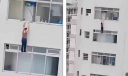 Vdeo: mulher fica pendurada em prdio ao limpar janela de apartamento (foto: Reproduo)