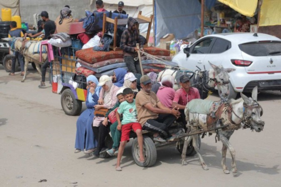 Palestinos chegam de carroa puxada por burro, em Khan Yunis, depois de fugirem de Rafah  (Crdito: Bashar Taleb/AFP)